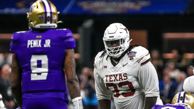 Texas Longhorns defensive lineman T'Vondre Sweat (93) watches Washington quarterback Michael Penix Jr. (9) before a snap during the Sugar Bowl College Football Playoff semifinals game at the Caesars Superdome on Monday, Jan. 1, 2024 in New Orleans, Louisiana.  